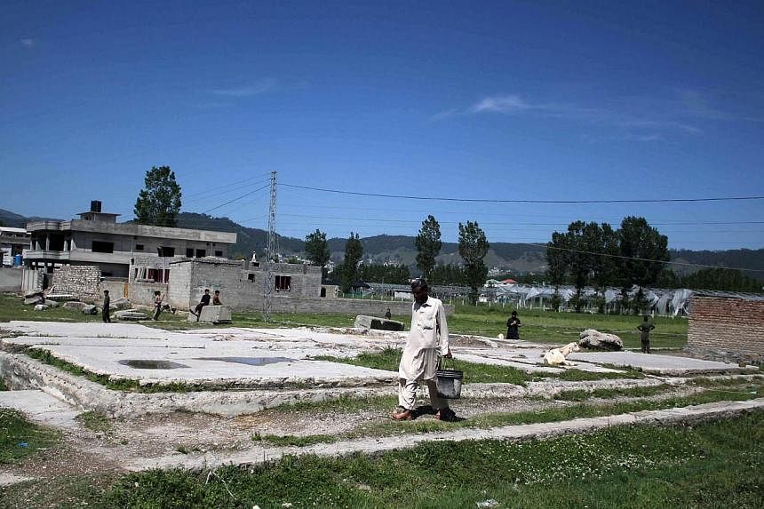 A man passing by the demolished site in Abbottabad, Pakistan, where Osama bin Laden was killed, on May 1, 2015, the fourth anniversary of his death. The White House has flatly rejected claims that Pakistan was told in advance about the 2011 special o