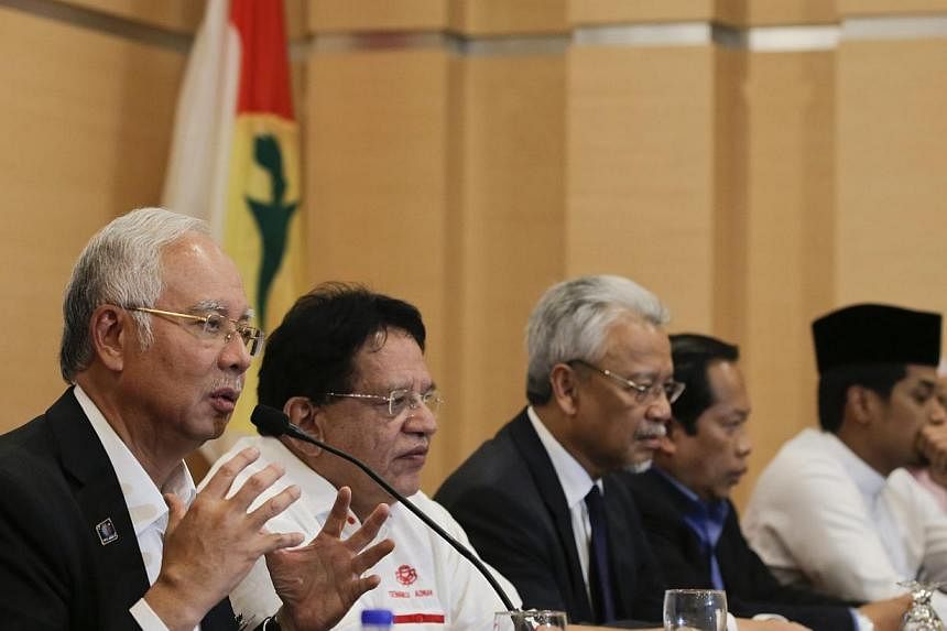 Malaysia's Prime Minister Najib Razak (left) speaks to members of the media during a news conference at Kuala Lumpur, Malaysia, on May 11, 2015. -- PHOTO: EPA
