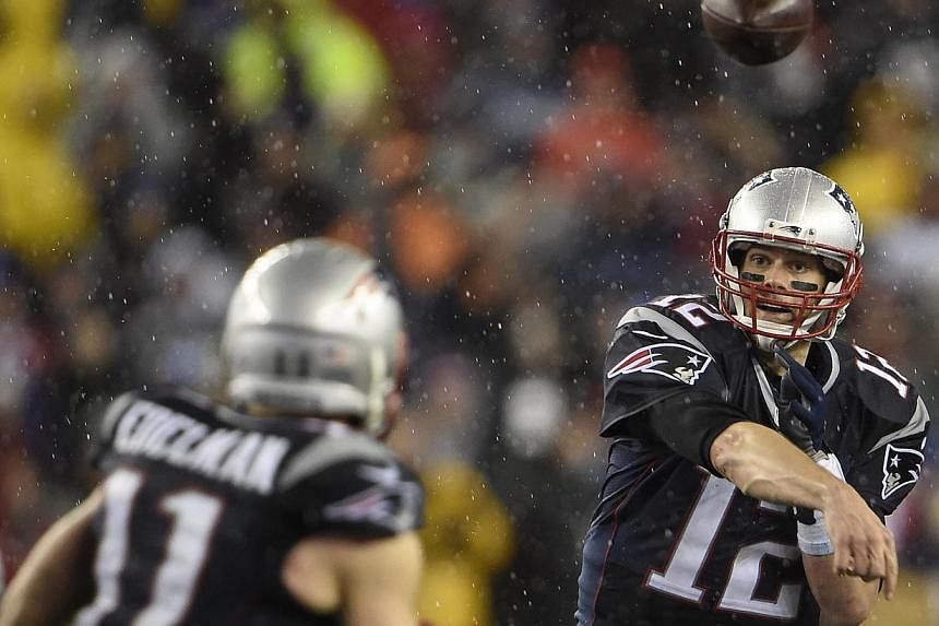 New England Patriots quarterback Tom Brady throwing a pass to Julian Edelman in the fourth quarter of their AFC Championship game at Gillette Stadium on Jan 18, 2015. -- PHOTO: EPA