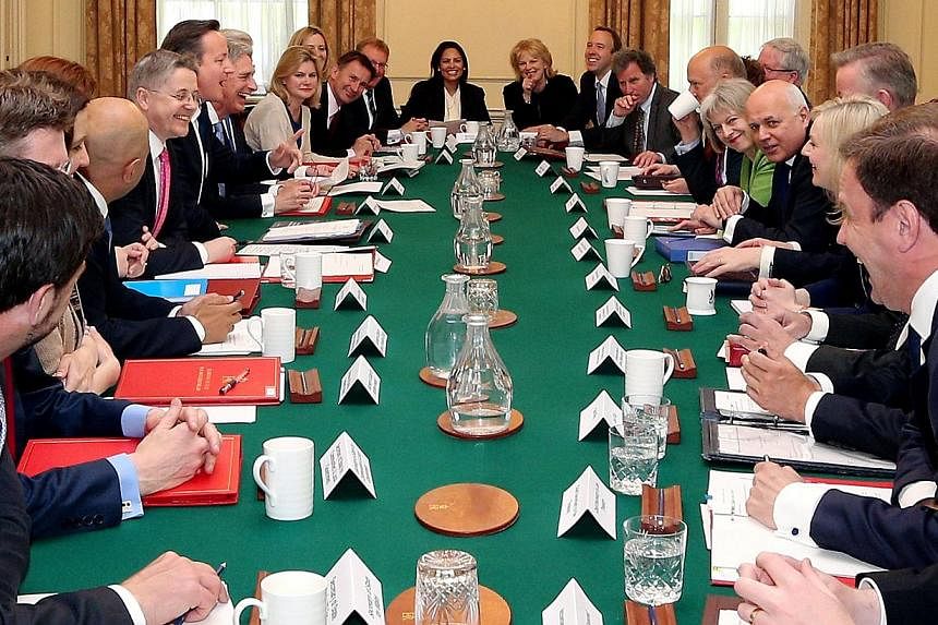 British Prime Minister David Cameron (seventh left) hosts the first weekly Cabinet meeting in Downing Street, central London, on May 12, 2015, following the May 7 general election.&nbsp;Cameron will hold an early referendum on membership of the Europ