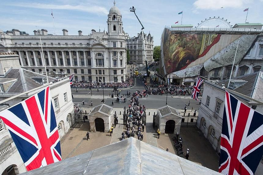 A handout photograph made available by the British Ministry of Defence showing a rooftop view from Horse Guards Parade of the VE Day Parade in central London, England, on May 10, 2015, after the service of Thanksgiving at Westminster Abbey. -- PHOTO:
