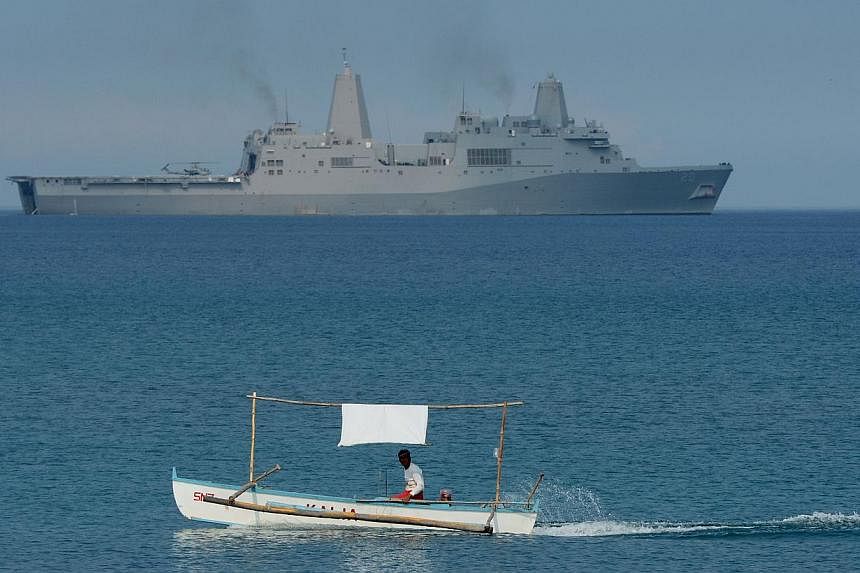 A Filipino fisherman sails past the US Navy amphibious transport dock ship USS Green Bay (LPD-20) during an amphibious landing exercise on a beach at San Antonio in Zambales province on April 21, 2015. China on Wednesday, May 13, said it was "extreme
