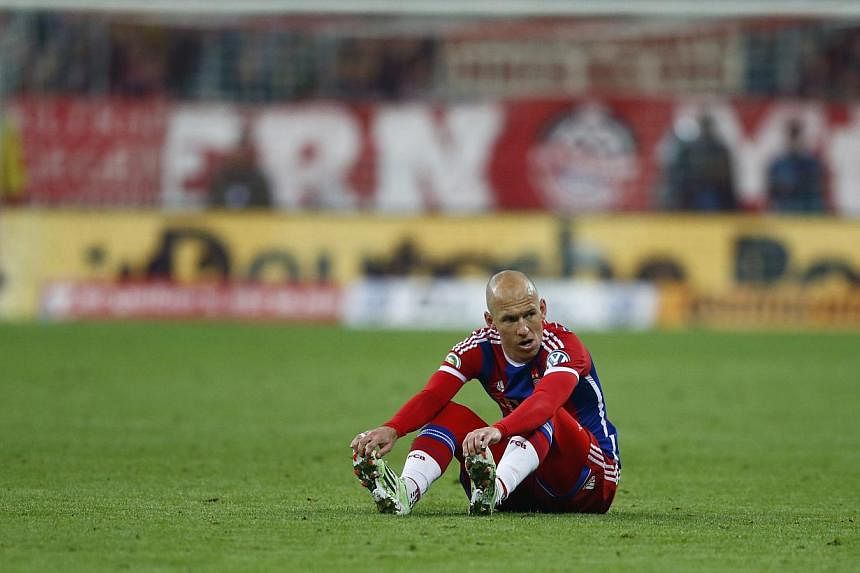 Bayern Munich's Arjen Robben sits on the pitch during their German Cup (DFB Pokal) semi-final&nbsp;football match against Borussia Dortmund in Munich, Germany&nbsp;on April 28, 2015. -- PHOTO: REUTERS