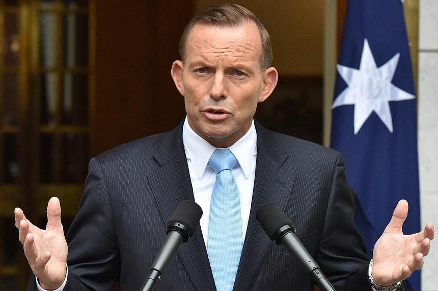 Australia's Prime Minister Tony Abbott speaking during a press conference after retaining the leadership of the Liberal party at Parliament House in Canberra on Feb 9, 2015. -- PHOTO: AFP