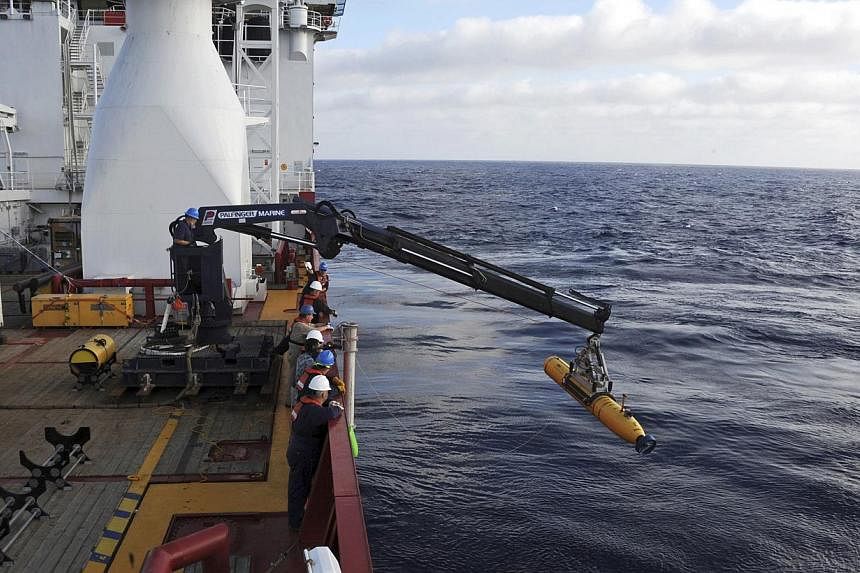 Operators aboard the Australian Defense Vessel Ocean Shield move the US Navy's Bluefin 21 autonomous underwater vehicle into position for deployment in the Southern Indian Ocean, as the search continues for the missing Malaysia Airlines Flight 370, i