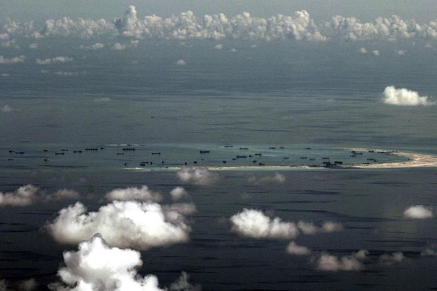 An aerial &nbsp;photo taken though a glass window inside a military plane of the alleged on-going reclamation by China into mischief reef in the Spratly group of islands in the South China Sea, west of Palawan, Philippines, on May 11, 2015. -- PHOTO: