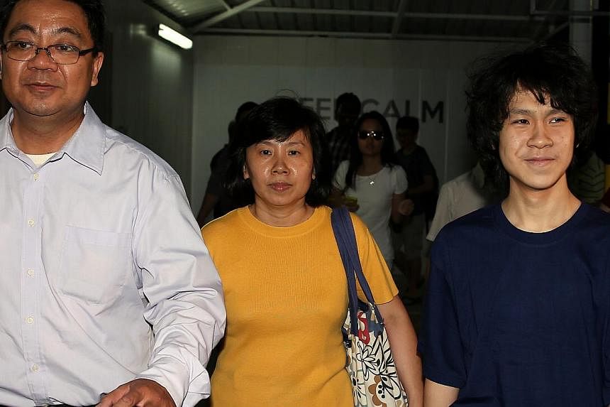 Amos Yee leaving the State Courts with his father Alphonsus Yee and mother Mary Toh yesterday. The teen was all smiles and took his time to ensure that the media got all the pictures it wanted.