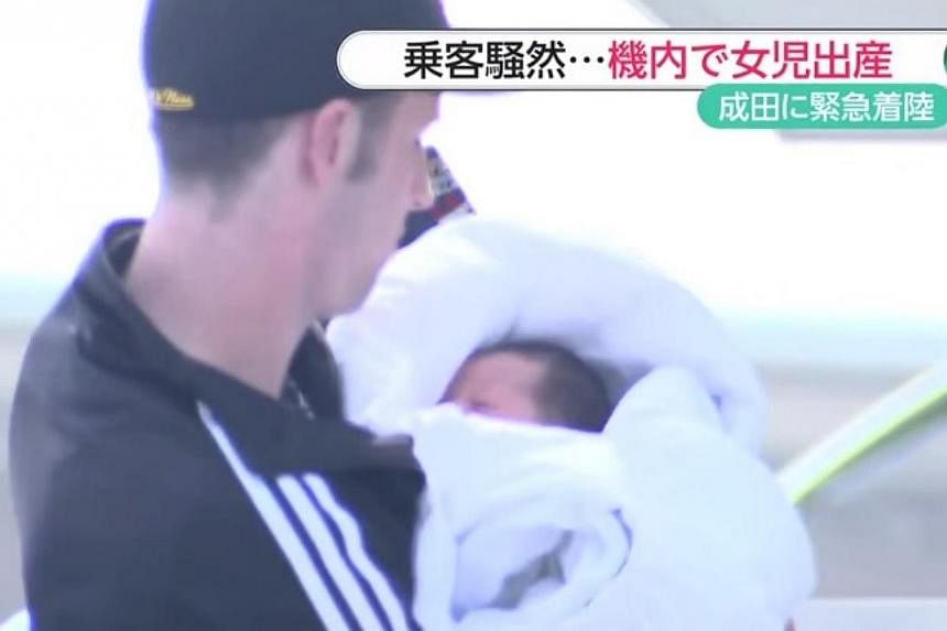 Canadian Wes Branch (pictured) holding his newborn daughter. He and his girlfriend Ada Guan were on an Air Canada flight from Calgary to Tokyo on Mother's Day when Ms Guan, who had no idea she was pregnant, gave birth. -- PHOTO: SCREENGRAB FROM YOUTU