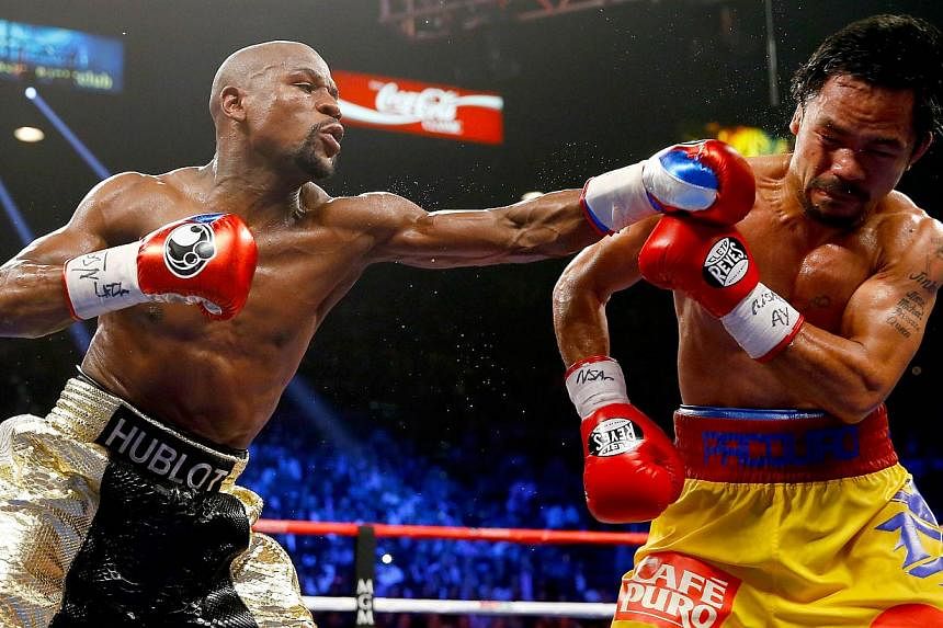 Floyd Mayweather Jr throws a left at Manny Pacquiao during their welterweight bout on May 2, 2015 in Las Vegas, Nevada. &nbsp;The “Fight of the Century” between boxing greats Floyd Mayweather Jr and Manny Pacquiao generated record pay-per-view re