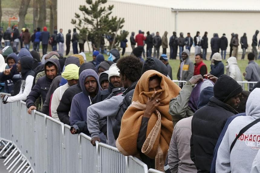 Migrants from Africa, Afghanistan and Syria queue for an evening meal at the Jules Ferry day center in Calais, France, on April 29, 2015.&nbsp;&nbsp;French police on Tuesday said they would probe a shocking video showing violence against migrants in 