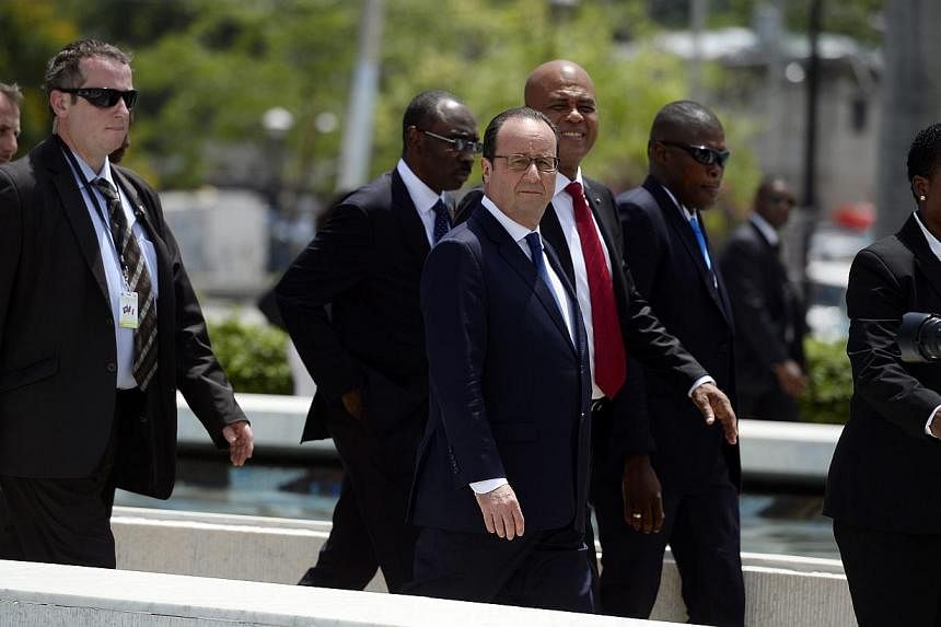 French president Francois Hollande (centre) and Haitian President Michel Martelly (third right) in Port-au-Prince, Haiti, May 12, 2015. &nbsp;President Francois Hollande arrived in Haiti on Tuesday to boost France's role in what was once its richest 