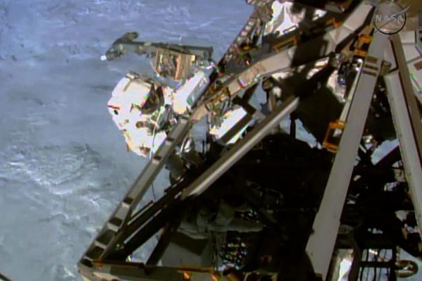 An image taken from Nasa video shows US astronaut Terry Virts during a spacewalk on March 1, 2015, preparing the International Space Station for the arrival of commercial space capsules in the coming years. Russia said Tuesday it would delay the retu