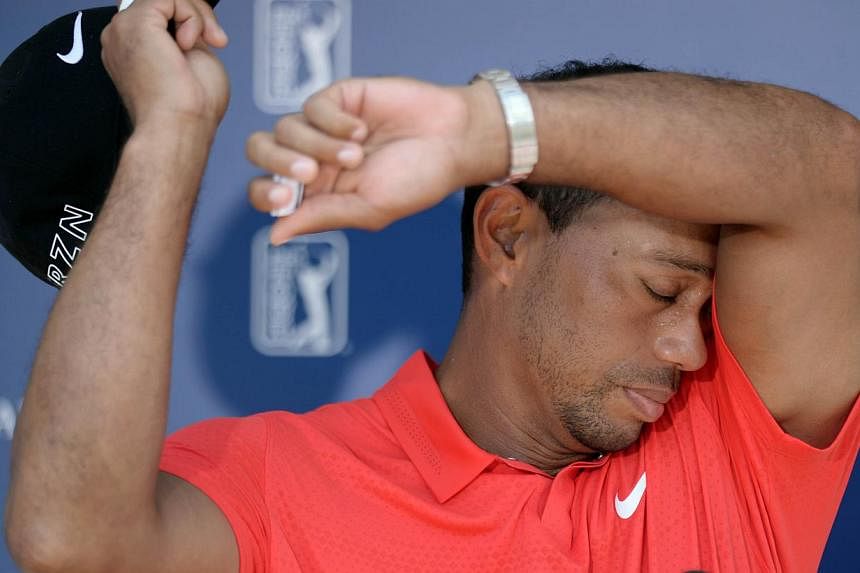 Tiger Woods wipes sweat from his head after completing the final round of The Players Championship at TPC Sawgrass - Stadium Course. He wrote a personal letter of support to a schoolboy who contemplated suicide because of a stutter, saying "I know wh
