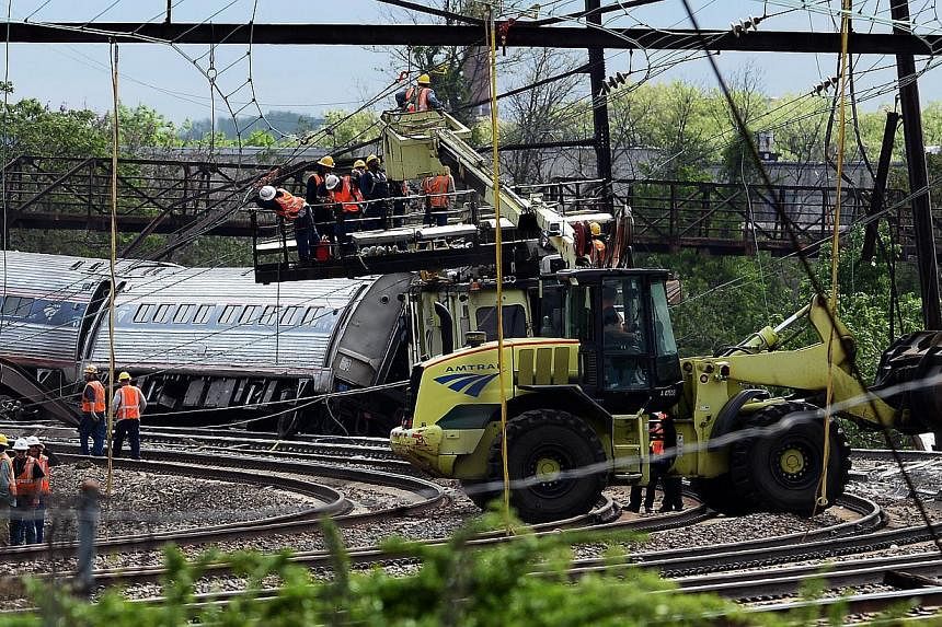 Rescuers work around the derailed carriages of an Amtrak train in Philadelphia, Pennsylvania, on May 13, 2015. -- PHOTO: AFP&nbsp;