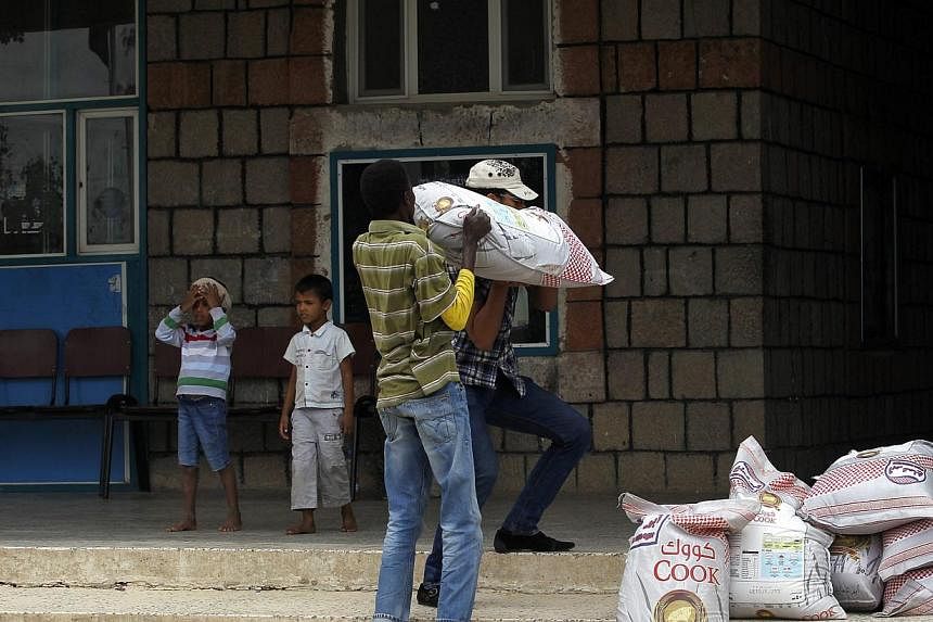 Volunteers carry aid provided for Yemenis affected by ongoing air-strikes carried out by the Saudi-led coalition inside a gymnasium turned into a temporary evacuation center in Sana'a, Yemen on May 3, 2015. A senior Iranian commander said it was Iran