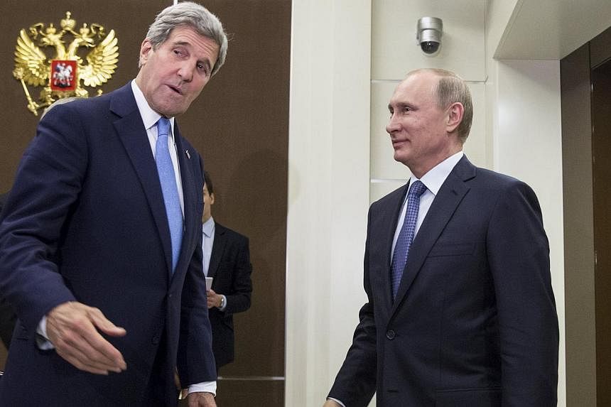 US Secretary of State John Kerry (left) speaks with Russian President Vladimir Putin before a bilateral meeting at the presidential residence of Bocharov Ruchey in Sochi, Russia May 12, 2015. -- PHOTO: REUTERS