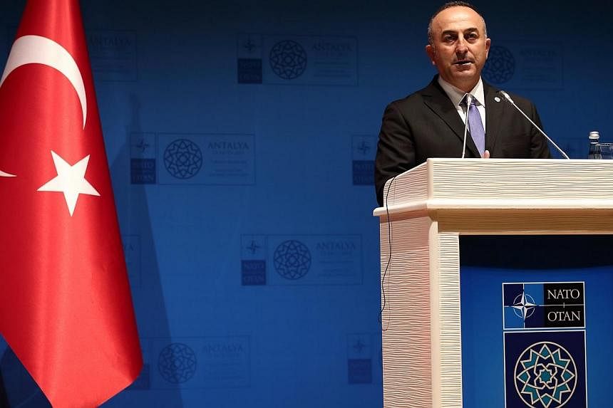 Turkish Foreign Minister Mevlut Cavusoglu speaks during a press conference at the NATO Foreign Ministers Summit in Antalya, Turkey on Tuesday. -- PHOTO: EPA