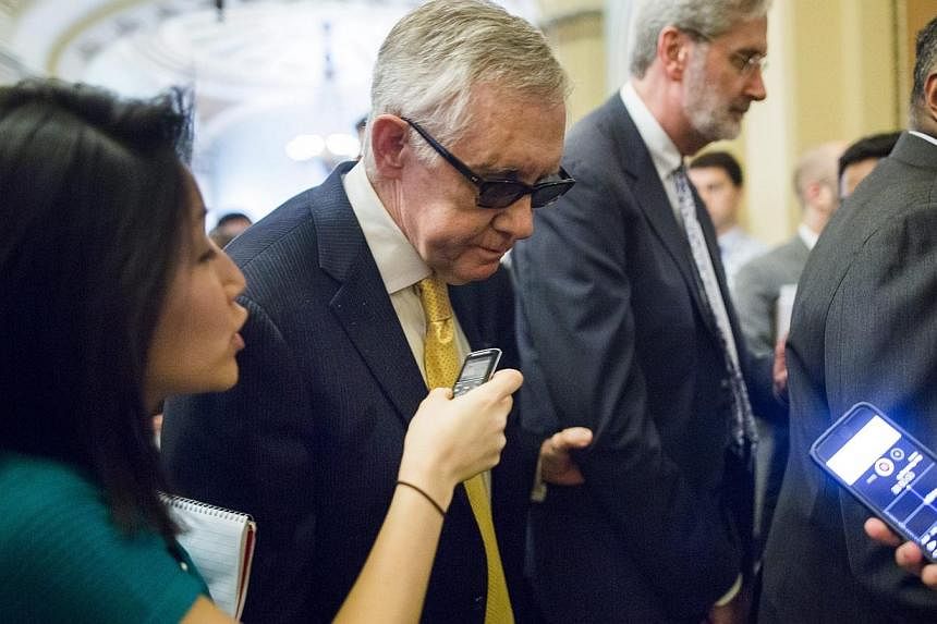 US Senate Minority Leader Democrat Harry Reid from Nevada walks to the Senate floor for a procedural vote on a much-debated trade bill in the US Capitol in Washington, DC, on Tuesday. The bill, which failed to progress in the Senate, would have given