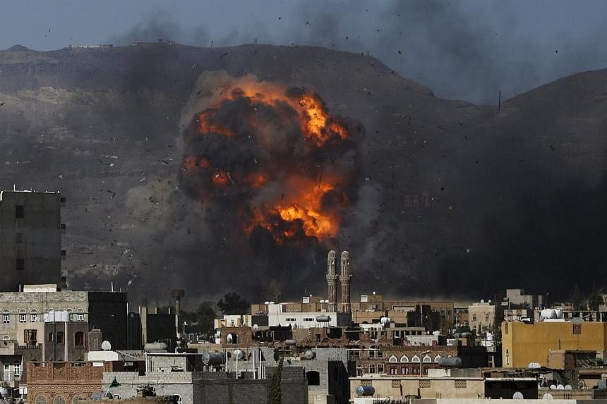 An air strike hits a military site controlled by the Houthi group in Yemen's capital Sanaa May 12, 2015. A ceasefire after weeks of Saudi-led coalition bombing in Yemen began on Tuesday night, but the coalition warned Iran-backed rebels that it would