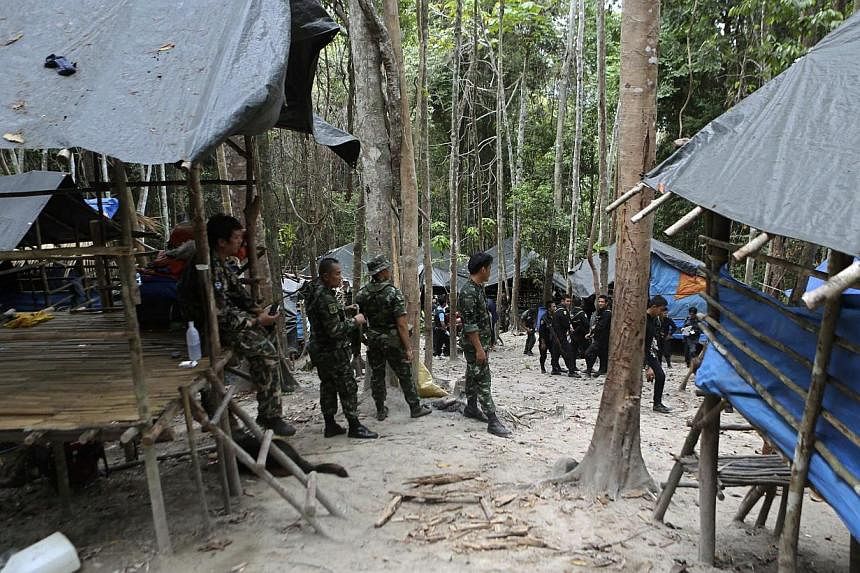 Thai soldiers securing an abandoned jungle camp believed to have been used by human traffickers to detain Rohingya migrants at a mountain in Sadao, Songkhla province, southern Thailand, on May 12, 2015. Thai police have stepped up a manhunt for the a