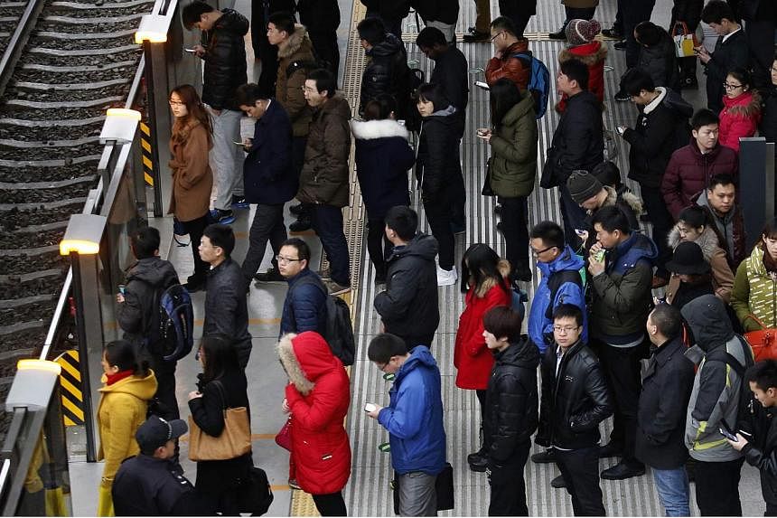 Passengers waiting for a train in Beijing on Feb 25, 2015. Beijing police are patrolling the city's subways and trains to stop people wearing face masks, strange costumes and forming flash mobs, warning commuters that such actions could jeopardise pu