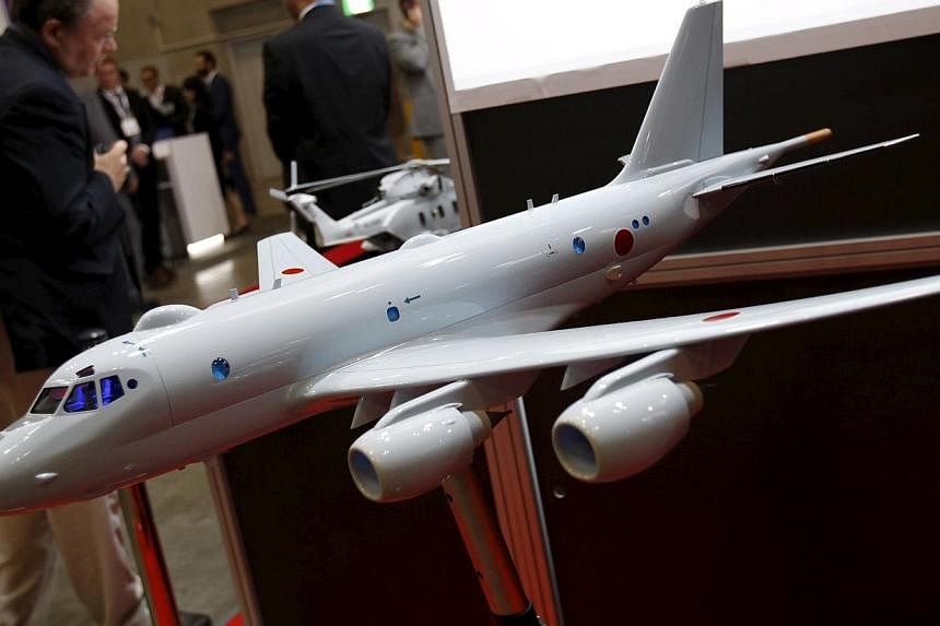 A model of a Japan Maritime Self-Defence Forces P-1 submarine-hunting aircraft is displayed at a defence exhibition in Yokohama on May 13, 2015. Japan's cabinet is set to approve Bills to implement a drastic shift in security policy allowing the mili