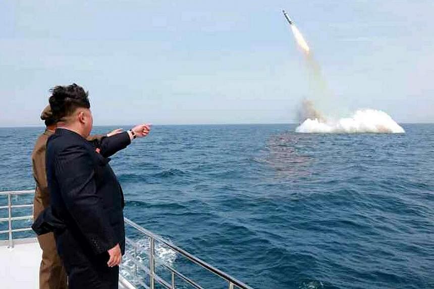 An image obtained by Yonhap News Agency shows North Korean leader Kim Jong Un pointing at a submarine-launched ballistic missile near Sinpo, on the north-east coast of North Korea on May 9, 2015. -- PHOTO: EPA