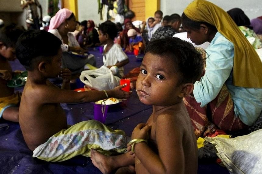 A child, believed to be Rohingya, eating inside a shelter after he was rescued along with hundreds of others on Sunday from boats in Lhoksukon, Indonesia's Aceh Province on May 12, 2015. -- PHOTO: REUTERS