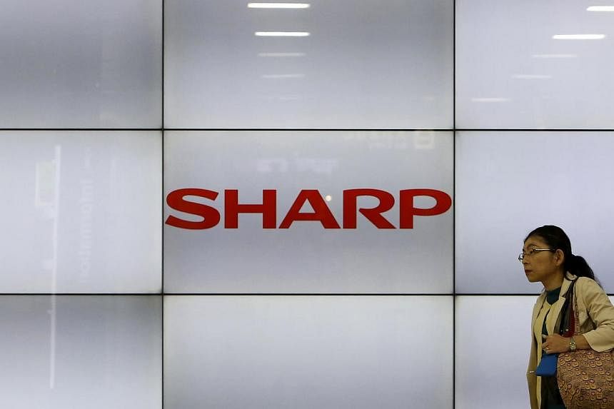 Japanese electronics giant Sharp will announce later on Thursday a US$1.68 billion (S$2.22 billion) fiscal year loss and thousands of job cuts as it fights to stay afloat, reports said. -- PHOTO: REUTERS