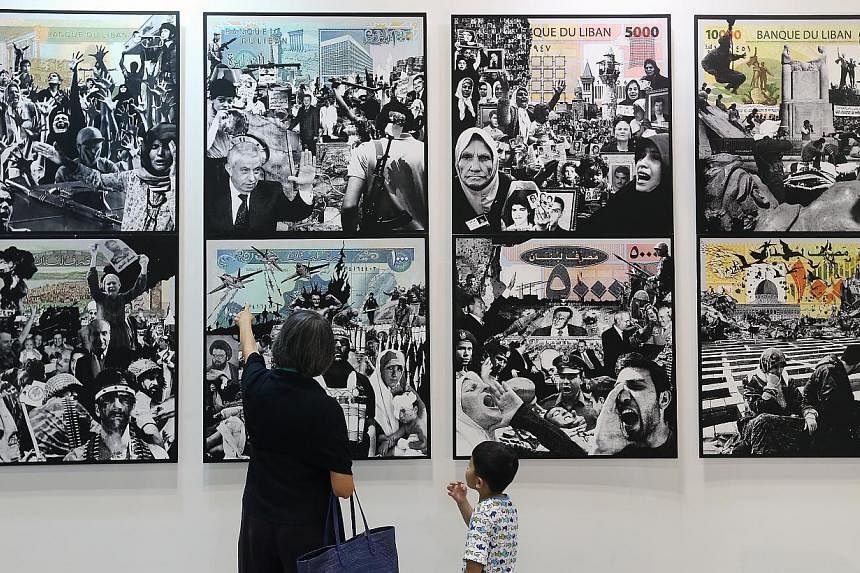 Visitors at the Singapore Art Fair at the Suntec Singapore Convention &amp; Exhibition Centre in 2014. A year after its first outing, the fair has "postponed" its 2015 edition. -- PHOTO: ST FILE