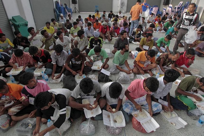 Suspected Rohingya migrants from Myanmar and Bangladesh have breakfast at Rattaphum district hall in Thailand's southern Songkhla province on May 9, 2015. -- PHOTO: REUTERS