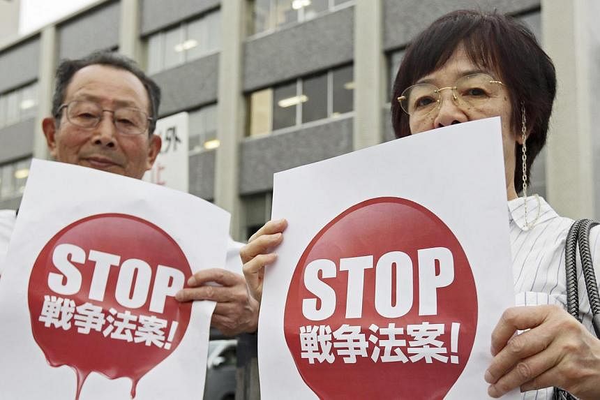 Demonstrators protesting against Japanese Prime Minister Shinzo Abe's Cabinet decision to change Japan's post-World War II defence security policy outside the prime minister's official residence in Tokyo, Japan, on May 14, 2015. -- PHOTO: EPA