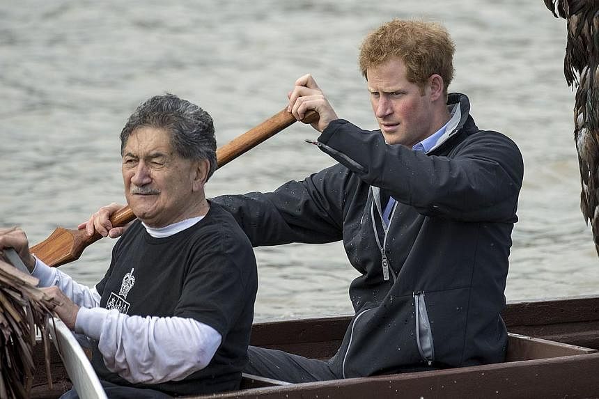 Britain's Prince Harry paddling in a Maori war canoe on the Whanganui river during a visit to Whanganui on May 14, 2015. -- PHOTO: AFP
