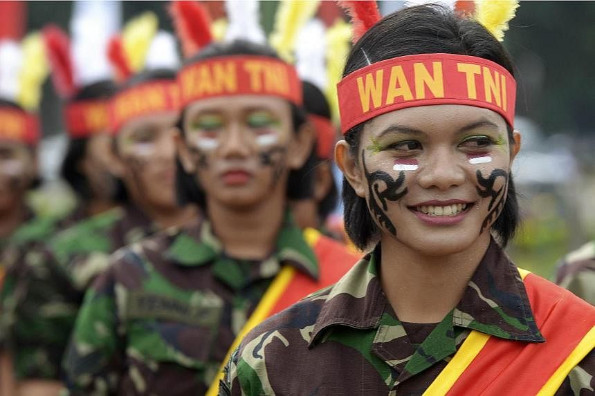 Female members of the Indonesian armed forces perform during the Kartini day ceremony commemorating the emancipation of Indonesian women in Jakarta on April 22, 2013.&nbsp;Indonesia faced calls on Thursday, May 14, 2015, to stop virginity tests for w