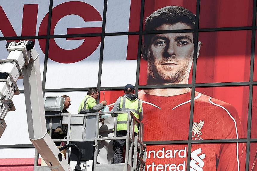 Workmen work on a poster of Liverpool's English midfielder Steven Gerrard outside The Kop stand at Anfield, Liverpool, on May 13, 2015.&nbsp;Tickets to &nbsp;the game, Gerrard's final home appearance, which usually cost 47 pounds (S$98),&nbsp;are on 