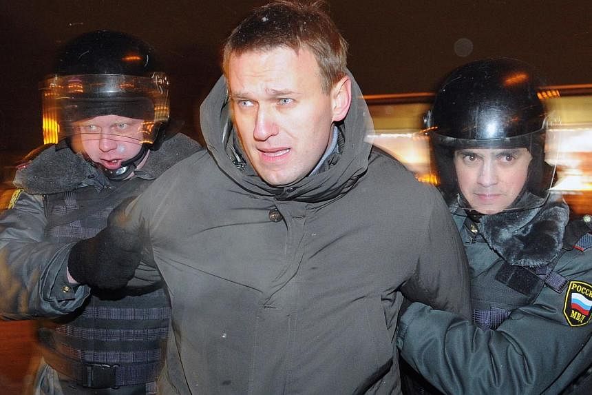 A file picture taken on on March 5, 2012, shows Putin critic Alexei Navalny being detained by police officers at Moscow's Pushkinskaya Square.&nbsp;A Moscow court on Wednesday ruled against jailing leading opposition politician Alexei Navalny after t