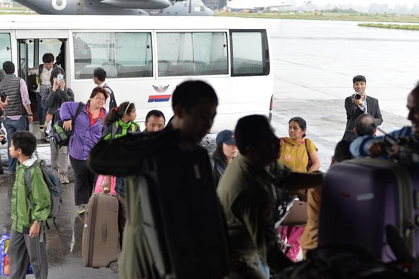 Singaporeans in Nepal boarding the RASF C130 on April 28, 2015. All Singaporeans in Nepal who are registered with the Ministry of Foreign Affairs (MFA) are safe following the latest earthquake, MFA said. -- ST PHOTO: CAROLINE CHIA