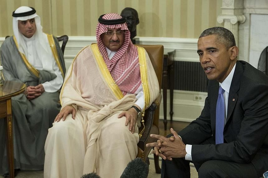 US President Barack Obama speaks to the press with Saudi Crown Prince Mohammed bin Nayef as Foreign Minister Adel al-Jubeir (left) looks on in the Oval Office at the White House in Washington, DC, on May 13, 2015. -- PHOTO: AFP&nbsp;