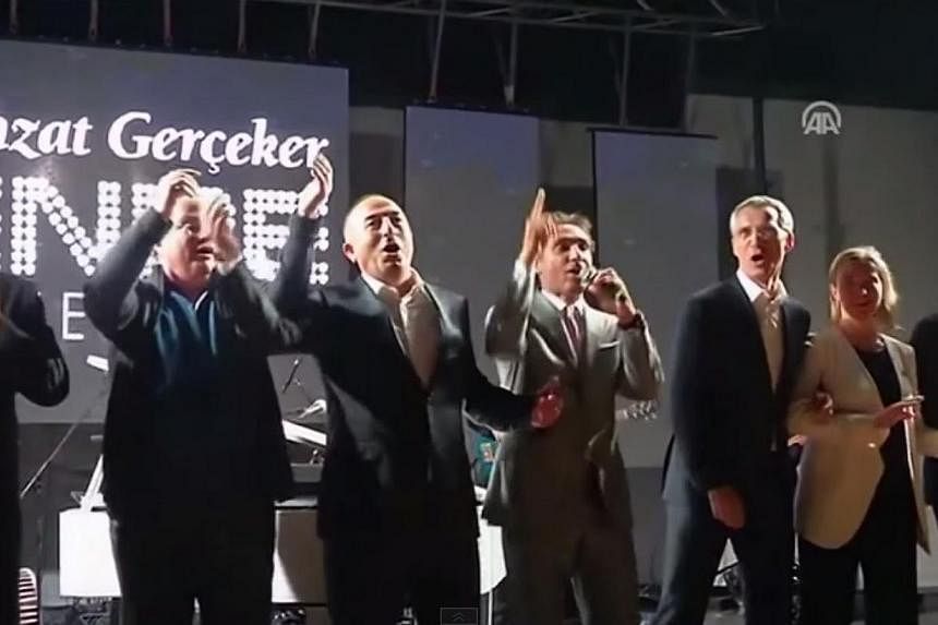 A screenshot from a video posted online of the We Are The World rendition at a&nbsp;dinner thrown for Nato foreign ministers at their two-day meeting in the southern Turkish city of Antalya. -- PHOTO: YOUTUBE