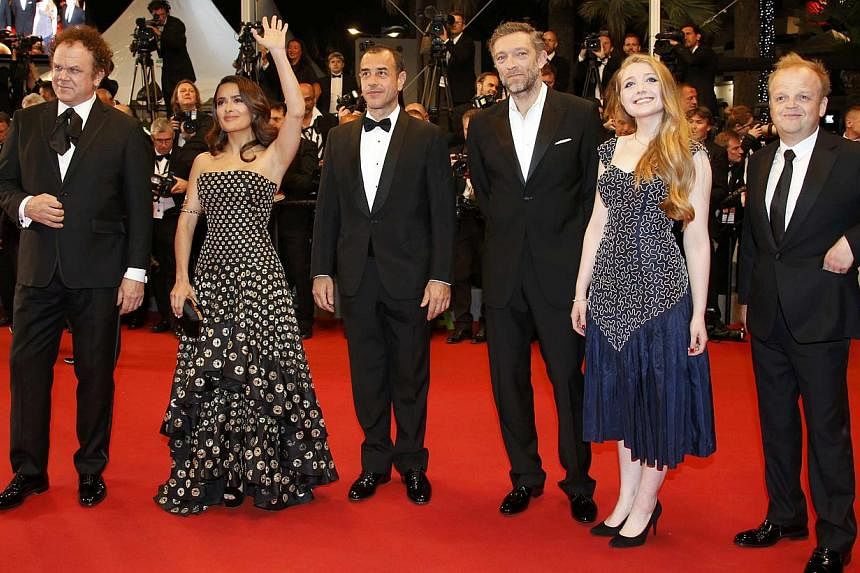 (From left) Cast members John C. Reilly, Salma Hayek, director Matteo Garrone, cast members Vincent Cassel, Bebe Cave and Toby Jones pose on the red carpet as they arrive for the screening of the film Tale Of Tales in competition at the 68th Cannes F