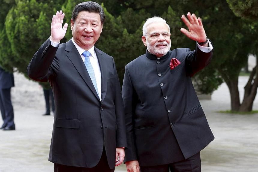 Chinese President Xi Jinping (left) and Indian Prime Minister Narendra Modi during their visit to the Dacien Buddhist Temple in Xi'an, Shaanxi province, on May 14, 2015. -- PHOTO: REUTERS&nbsp;