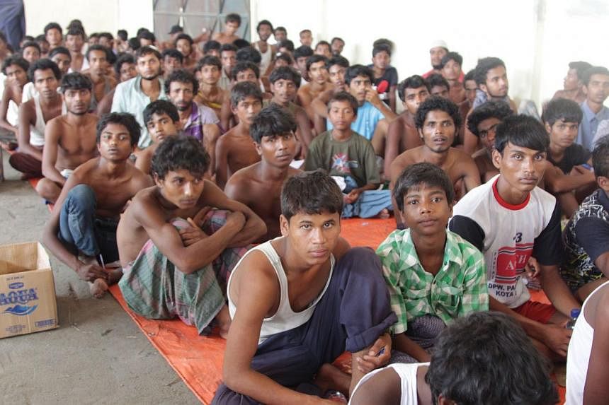 A group of rescued migrants from Myanmar and Bangladesh at a confinement area in the fishing town of Kuala Langsa in Aceh province on May 15, 2015. Myanmar may snub a regional meeting hosted by Thailand later this month aimed at easing the current Ba