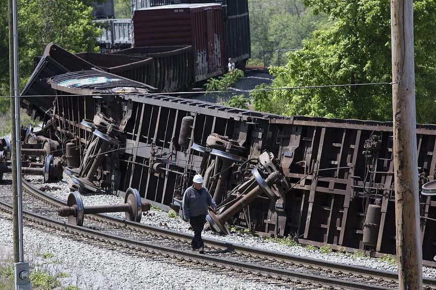 An investigator surveying the derailed Amtrak train in Pittsburgh, Pennsylvania, on May 14, 2015. Rescuers with sniffer dogs found an eighth victim on Thursday in the mangled wreckage, as investigators focused on the engineer's actions in the run-up 