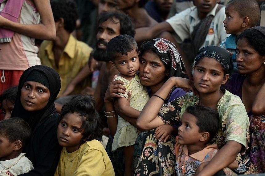 Rohingya migrants on a boat drifting in Thai waters off the southern island of Koh Lipe in the Andaman sea on May 14, 2015. Around 900 Rohingya and Bangladeshi migrants arrived in Indonesia and Thailand on Friday. -- PHOTO: AFP