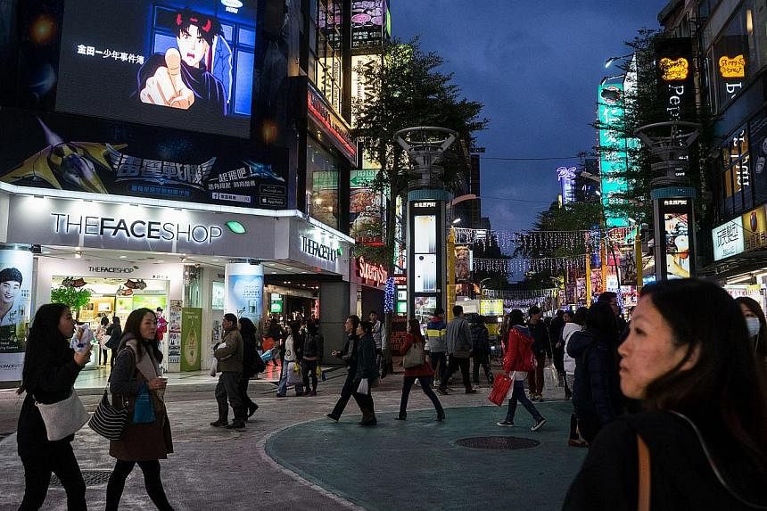 Pedestrians in the shopping district of Ximending in Taipei, on Dec 8, 2014. Taiwan on Friday began enforcing stricter rules on inspecting imported Japanese food products potentially originating in radiation-exposed areas, prompting a warning from To