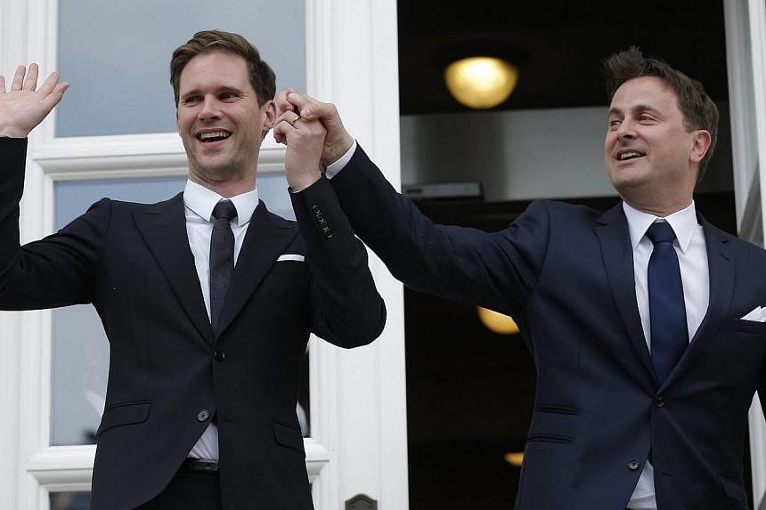 Luxembourg's Prime Minister Xavier Bettel (right) and Gauthier Destenay (left) pose for a photo after they got married in Luxembourg, on May 15, 2015. Bettel is reported to be the EU's first serving leader to marry someone of the same sex. -- PHOTO: 