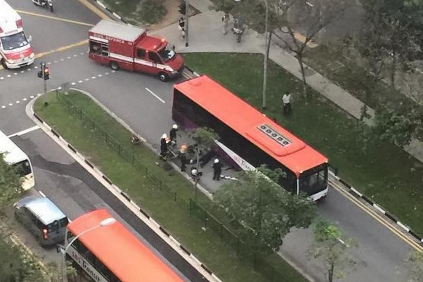 A woman had to be pulled out from underneath an SBS bus after an accident outside Punggol Bus Interchange on Friday morning. -- PHOTO: FACEBOOK