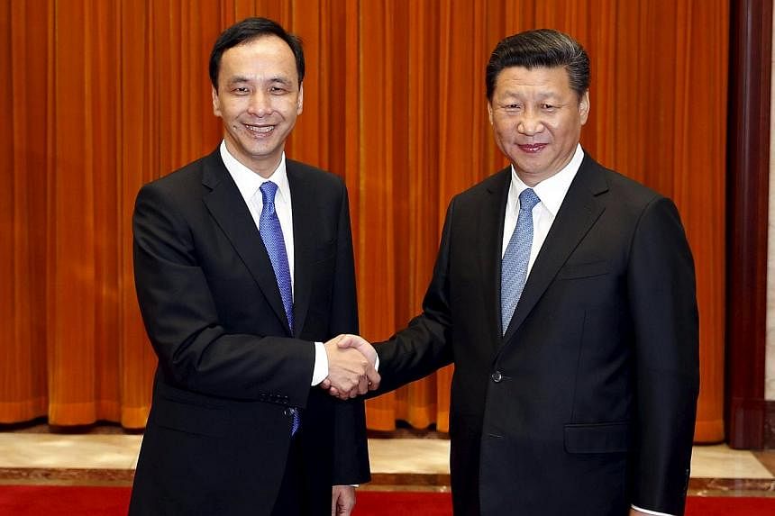 Chairman of Taiwan's ruling Nationalist Kuomintang Party (KMT) Eric Chu, also New Taipei mayor, shakes hands with China's President Xi Jinping as they pose for pictures during their meeting in Beijing, China on May 4, 2015. -- PHOTO: REUTERS