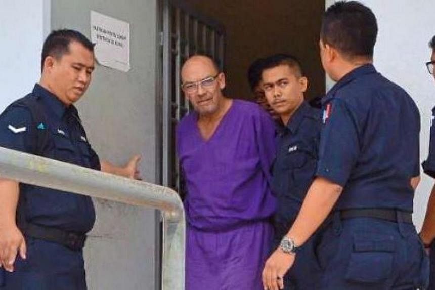 Dietmar Ross being taken away by the police after he was sentenced in Sepang. -- PHOTO: THE STAR/ASIA NEWS NETWORK