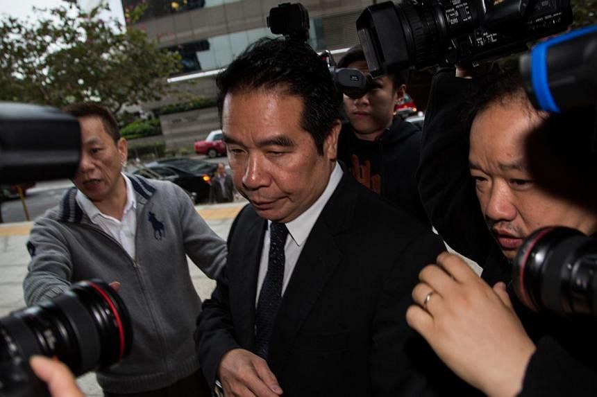 Carson Yeung, owner of Birmingham City Football Club and former chairman of Birmingham International Holdings Ltd., is surrounded by members of the media as he enters the Wanchai Law Courts in Hong Kong, China, on Friday, Feb. 28, 2014. -- PHOTO: ST 